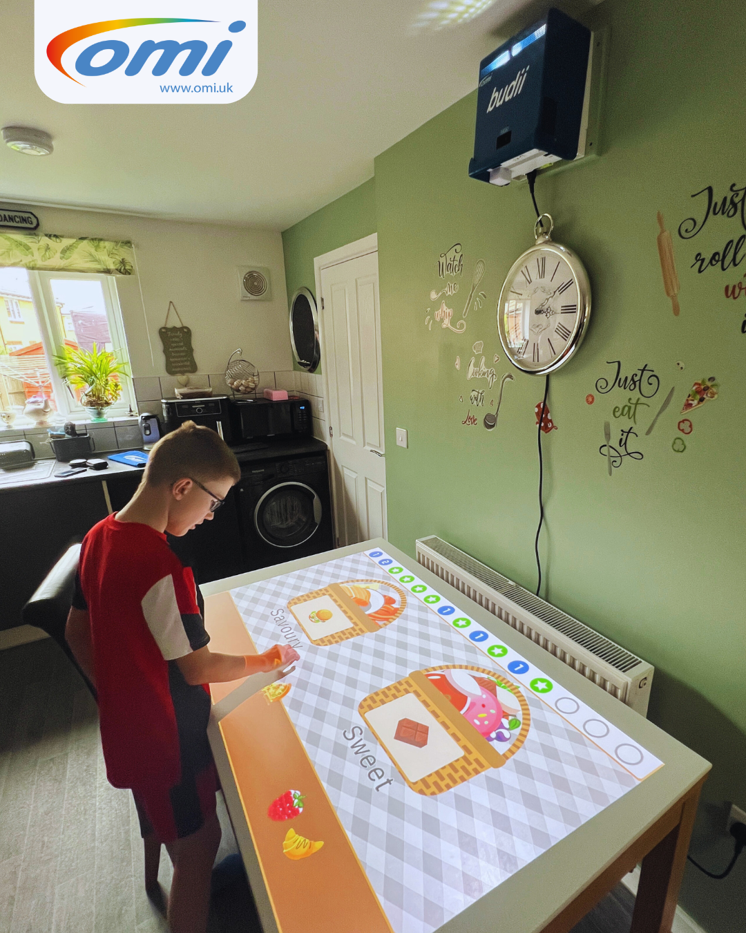 Child using Budii interactive projection at home with family support
